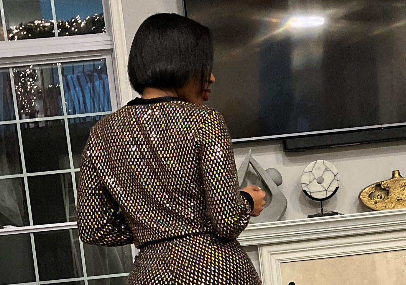 Woman modeling back of shiny patterned dress