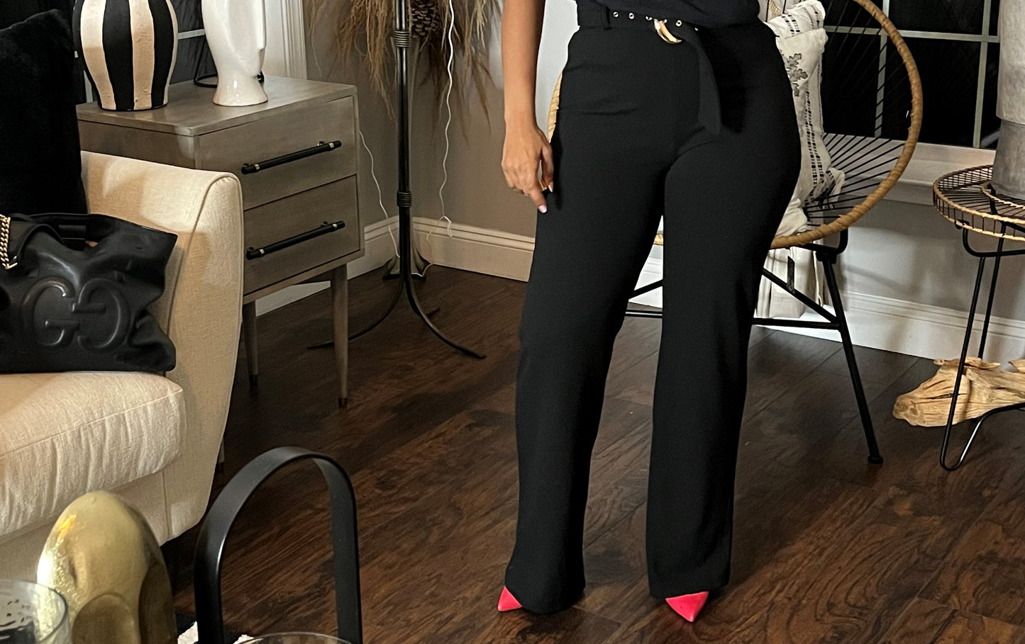 Woman modeling black straight-leg pants with fabric belt