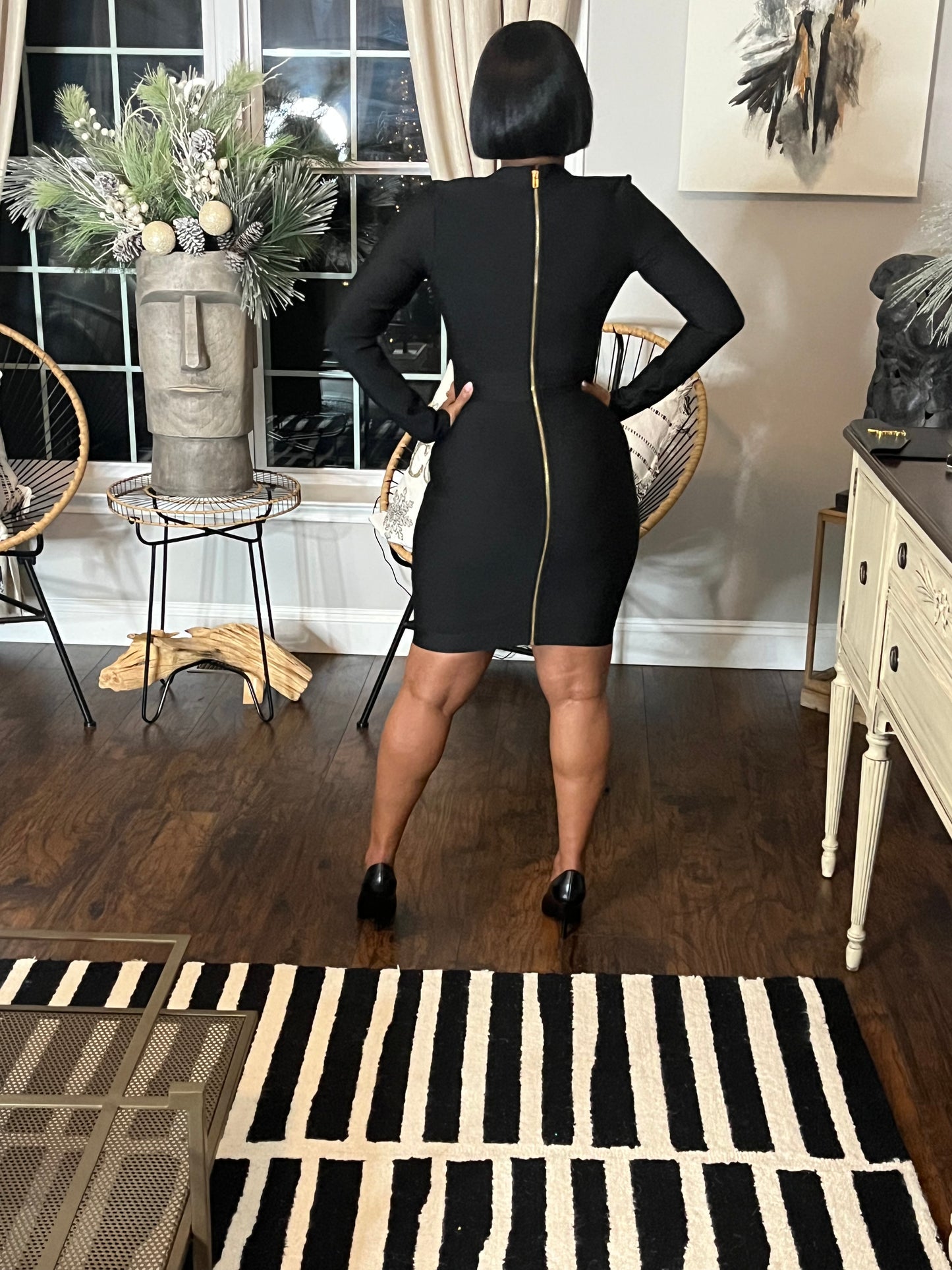 woman modeling black dress with zip up back