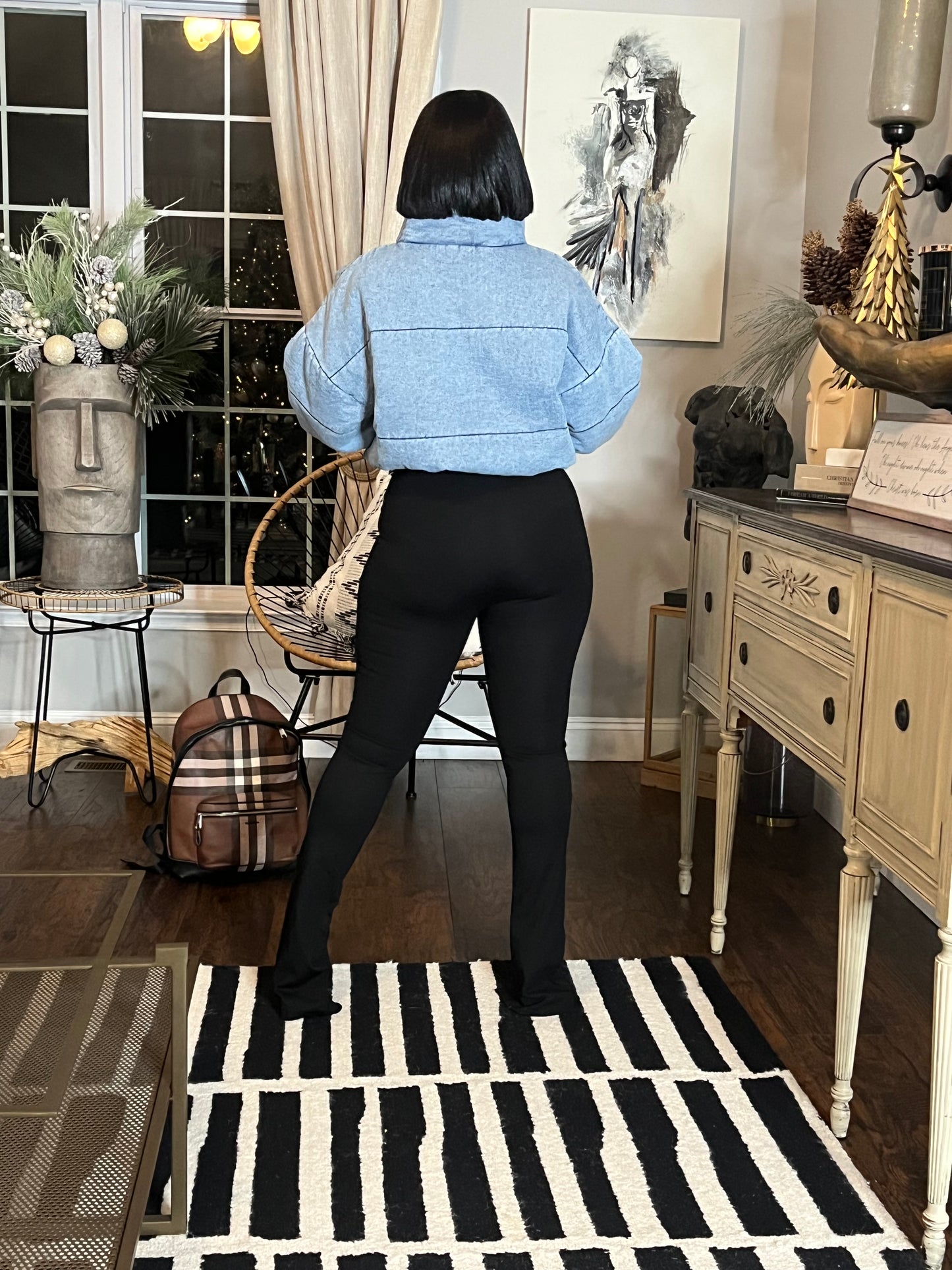 Women modeling fitted black pants and puffy jacket