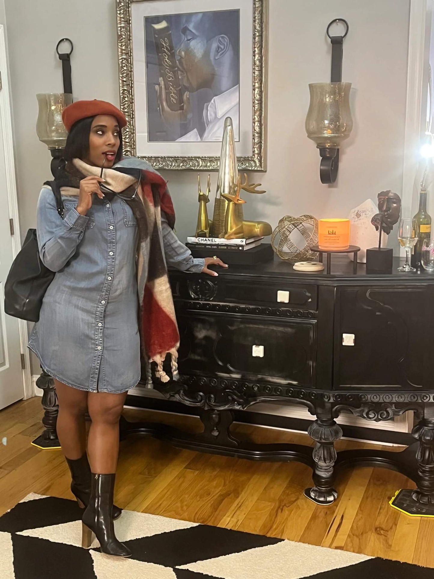 Woman dressed in denim dress with orange hat and patterned scarf